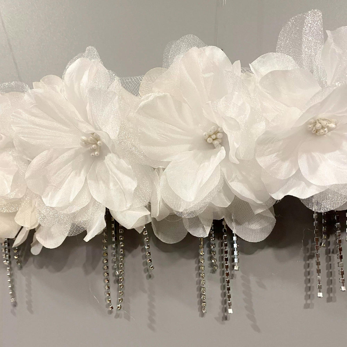 White Avant-Garde Floral Silk Blossoms Crystal Masquerade Mask displayed as wearable art