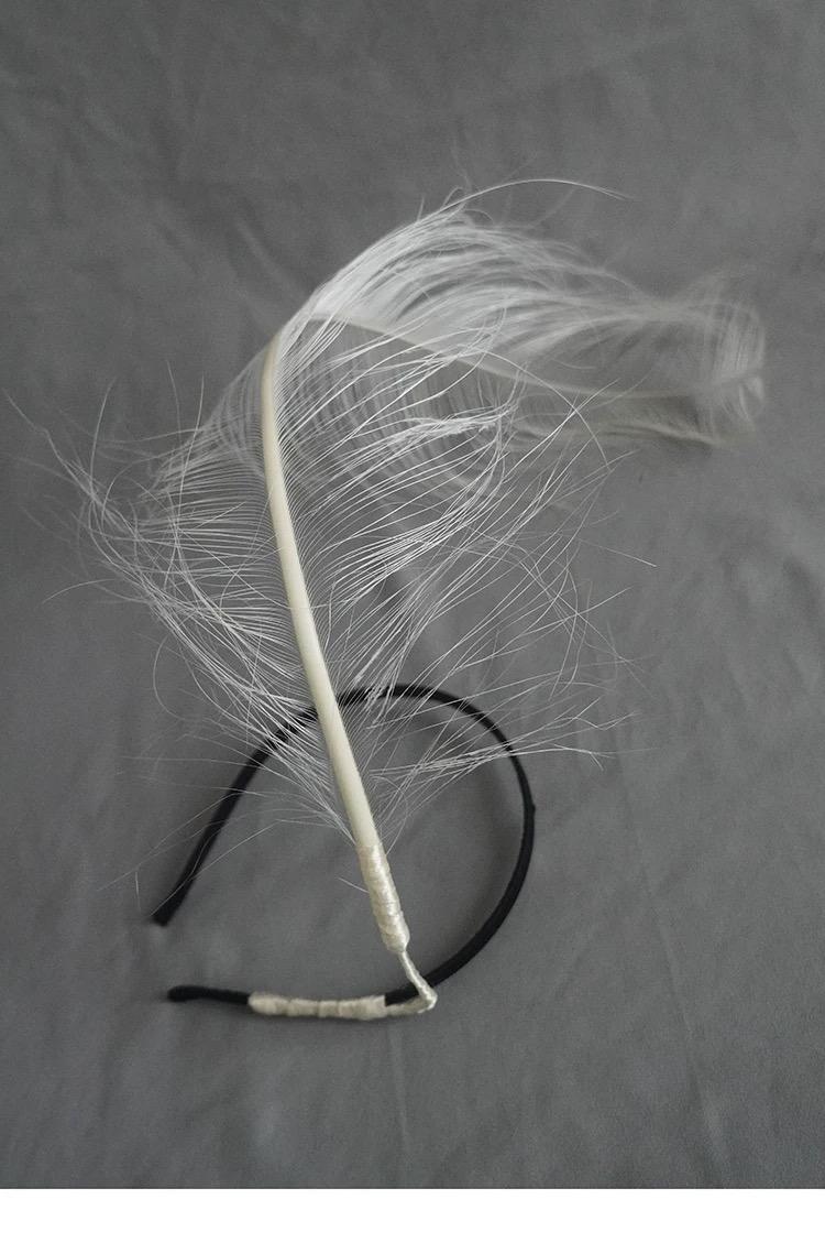 Detailed view of the handmade White Ostrich Feather Minimalist Avant Garde Headpiece