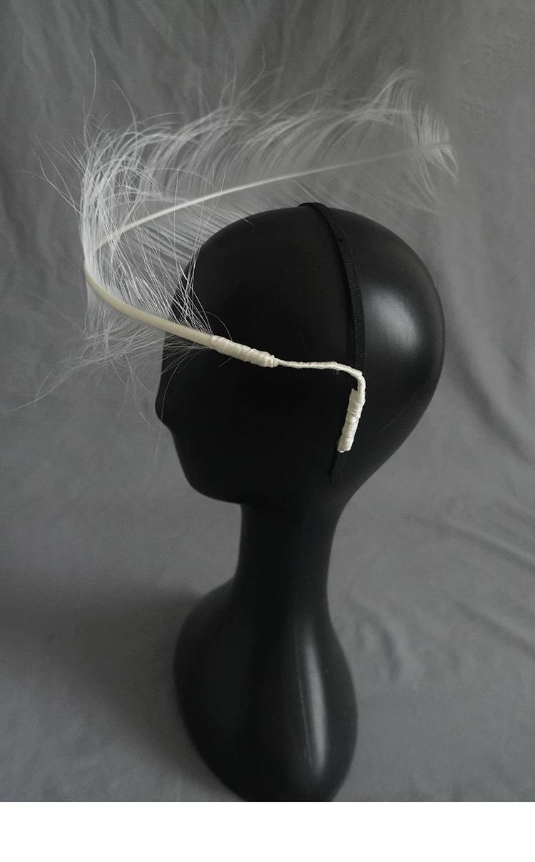 White Ostrich Feather Minimalist Avant Garde Headpiece displayed as wearable art